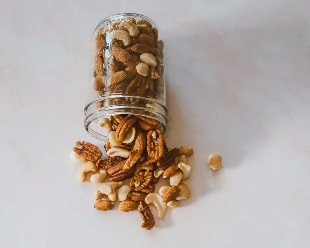 A well-organized pantry with macadamia nuts stored in a high, locked cabinet away from a curious dog looking up, demonstrating proper food safety storage